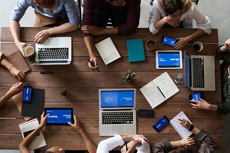 Employees meeting at table discussing business performance