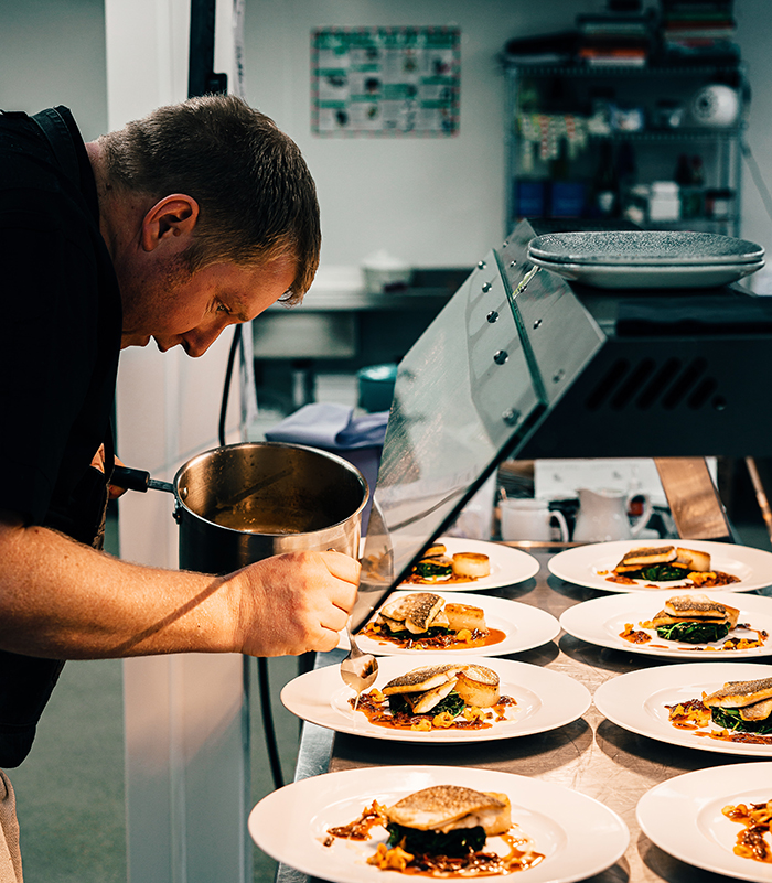 Chef serving food for service in fine dining restaurant