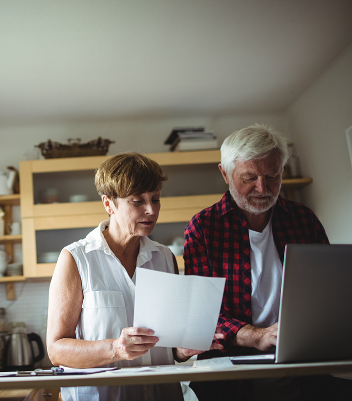 Couple reviewing financial documents at desk