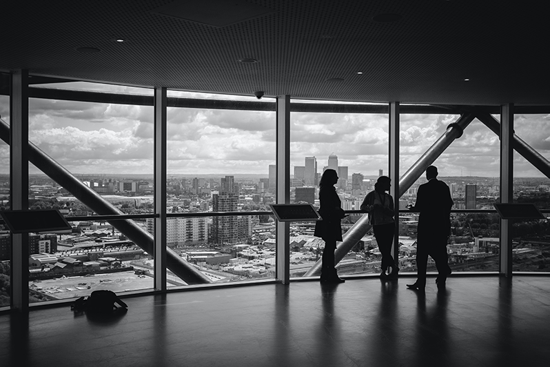 A group of people meeting in an office overlooking a city | Business Savers