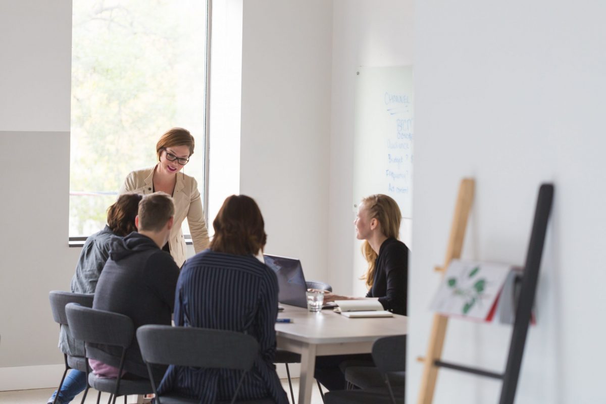 Group of people meeting A team of employees meeting in an office | Business Savers