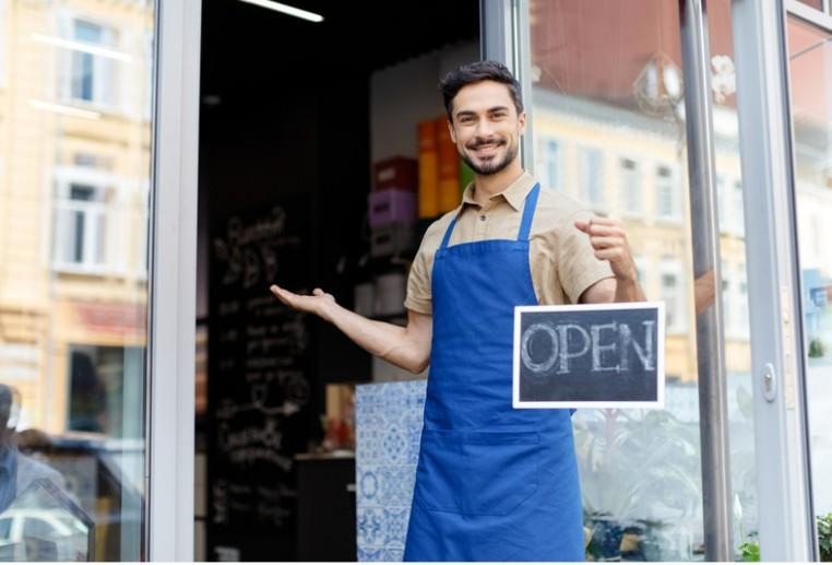 Small business owner in front of store